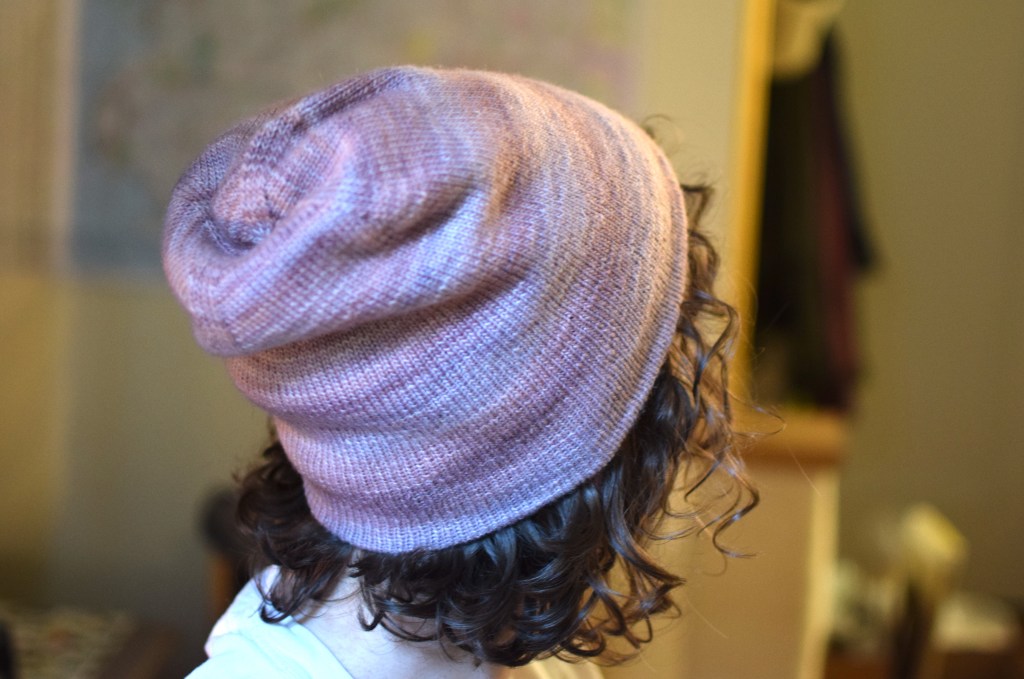 a hand-knitted pink hat.